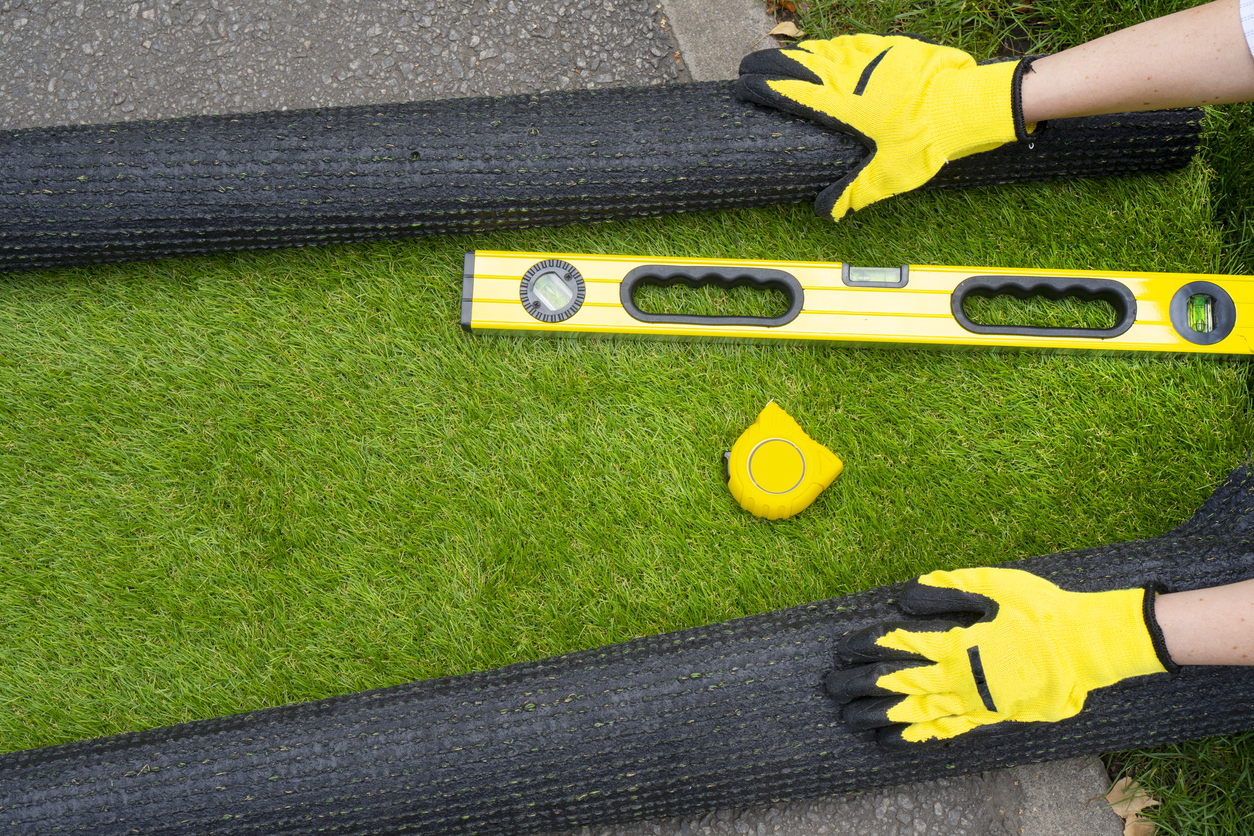 Installer measuring synthetic grass