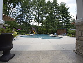 landscaped theater with seating, backyard playground and pool