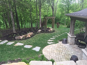 pathways trailing from patios into nearby woods in a rural retreat